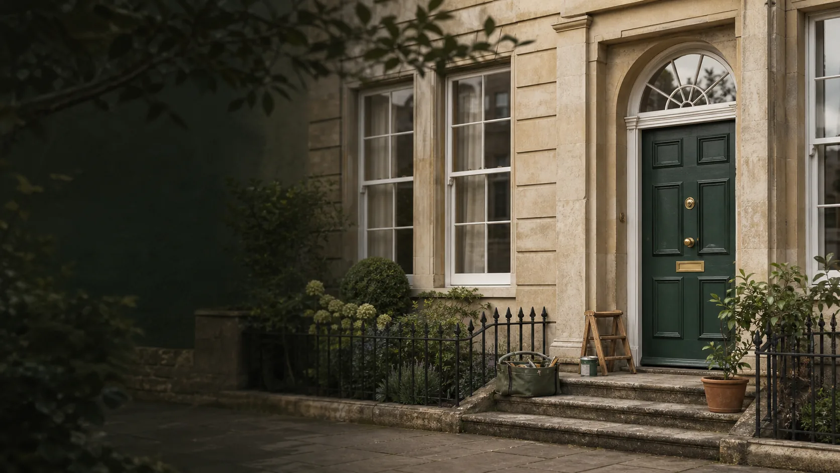 Illustrative Bath-style stone home with a green front door; not a photograph of a completed AHAH customer job.